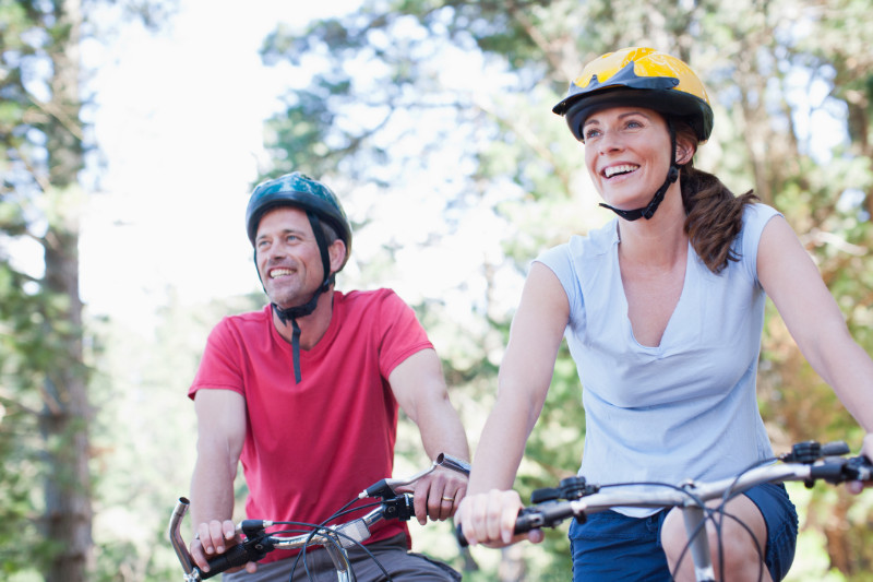 Couple bicycle riding in forest